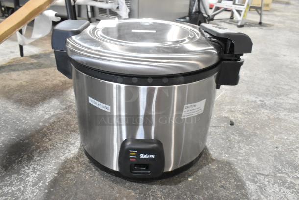 Brand new Galaxy 177RCSG60 electric rice cooker/warmer. Scratch and dent condition, 120V, 1 phase. Caution labels visible.