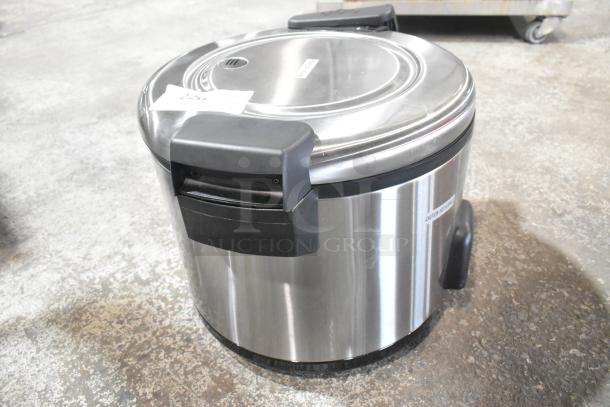 Brand new Galaxy 177RCSG60 electric rice cooker/warmer, stainless steel, 120V, some minor scratches, label indicates caution.