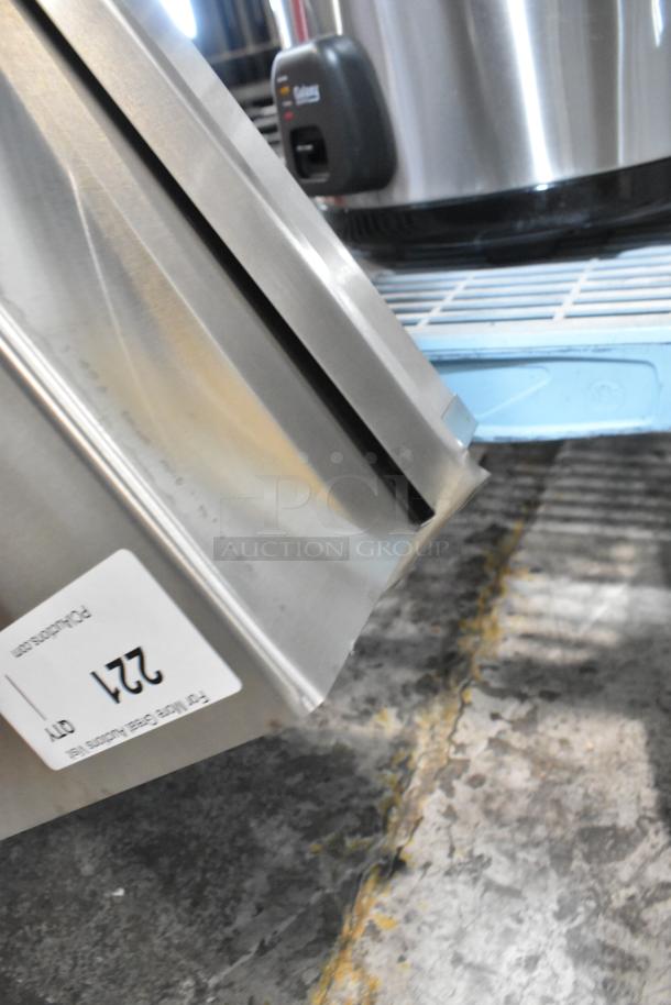 Brand new stainless steel wall mount trash and towel dispenser with minor scratches, shown with a visible label "221".
