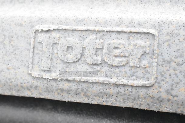 Close-up of a speckled gray plastic texture with embossed "Toter" logo, likely on a 12 poly trash can set, in good condition.
