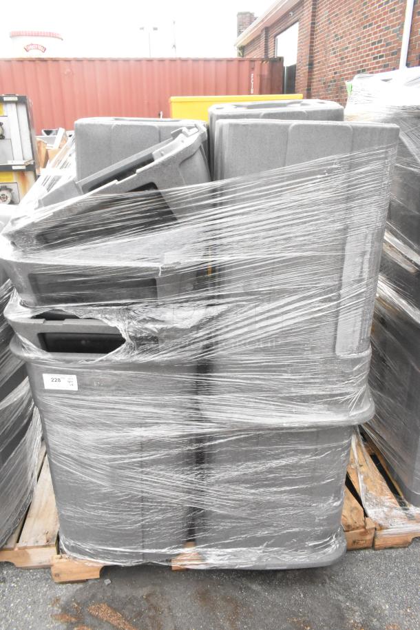8 poly trash cans bundled on a pallet with protective wrap, auction lot 228. Rugged design for commercial use.