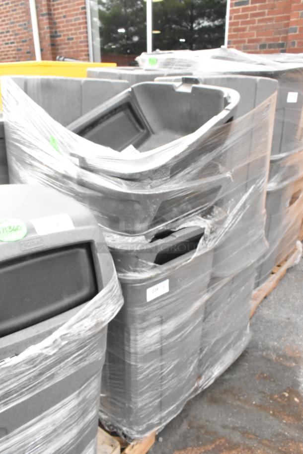 Eight poly trash cans stacked and wrapped, shown outdoors. Includes eight units per bid in good condition.