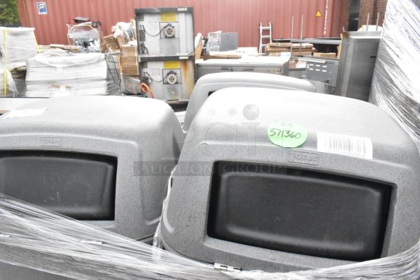Three gray poly trash cans with swing lids, labeled "Toter," wrapped in plastic. Tag reads "RS 371360."