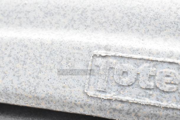 Close-up of a gray, speckled texture with embossed "Totes" marking, part of poly trash cans for auction.