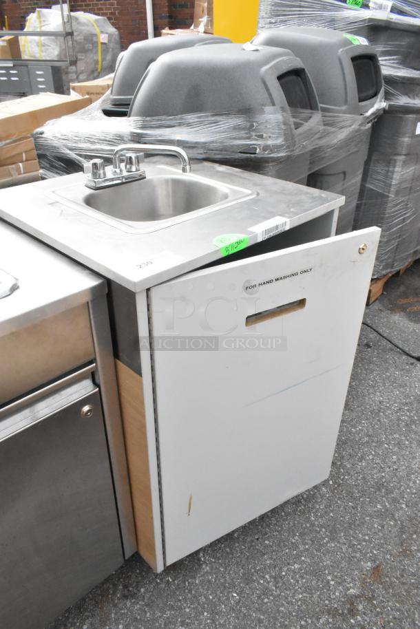 Stainless steel single bay portable sink on commercial casters, labeled for hand washing only. Minimal wear visible.