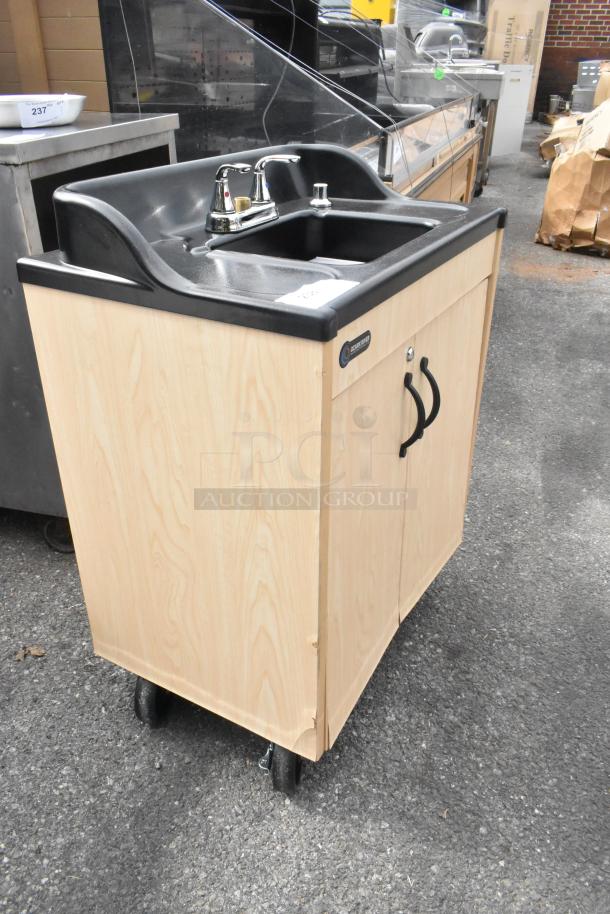 BRAND NEW Ozark River portable hot water hand sink with maple laminate cabinet and single basin on commercial casters.