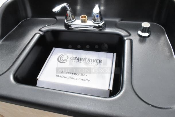 Brand new Ozark River portable hot water hand sink with single basin, laminate cabinet, and chrome faucet.