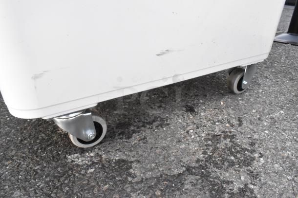 BRAND NEW Cambro IBS20148 21-gallon white storage bin, slant top, 2-piece sliding lid, on wheels, with visible scratches.