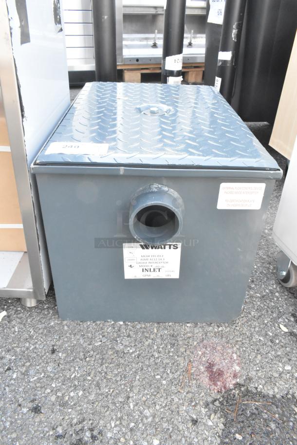 Brand new Watts WD-20 grease interceptor, 40 lb. capacity, scratch and dent condition; features inlet label and certification details.