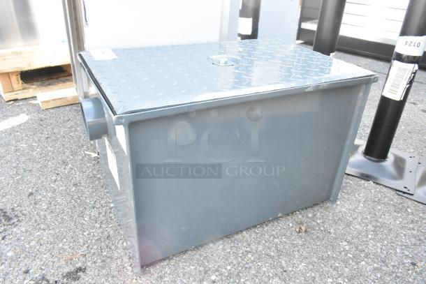 BRAND NEW Watts WD-20 grease interceptor, 40 lb. capacity, steel, scratch and dent condition, visible label on side.
