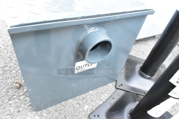 BRAND NEW Watts WD-20 grease interceptor with slight scratches. 40 lb. capacity, gray metal, labeled "OUTLET."