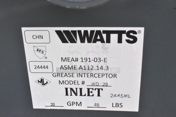 BRAND NEW Watts WD-20 Grease Interceptor, 40 lb. capacity, scratch and dent, model tag showing specs and compliance labels.