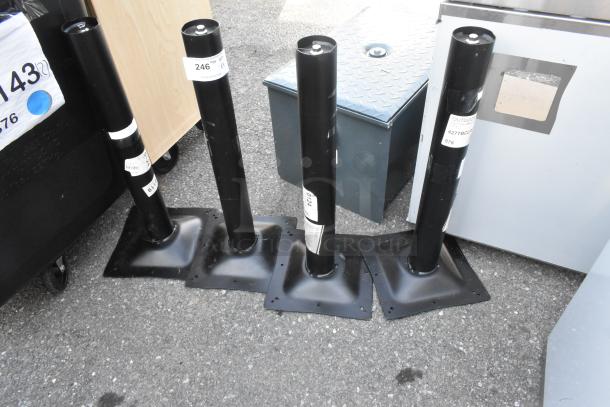 Four brand new 427TBCLRD325 Lancaster outdoor table base columns, black, standard height, labeled with model and tags.