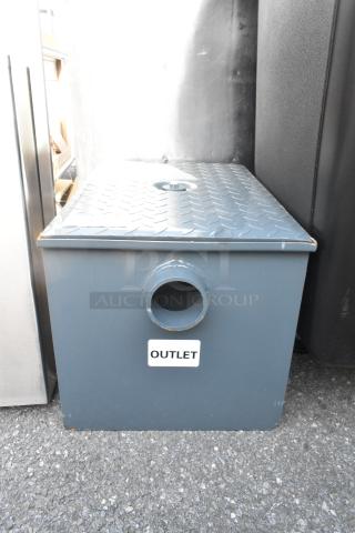 Brand new, scratch and dent Watts WD-20 grease interceptor. Features 40 lb capacity, rugged design, visible "OUTLET" label.