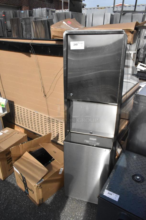 Brand new stainless steel wall mount trash and towel dispenser with visible scratch and dent, packaging included.