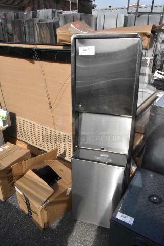 Brand new stainless steel wall mount trash and towel dispenser with visible scratch and dent, packaging included.
