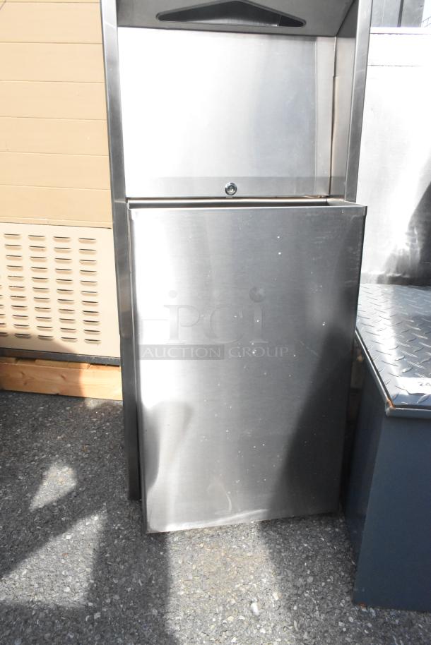 Stainless steel wall mount trash and towel dispenser. New condition, minor scratches visible.