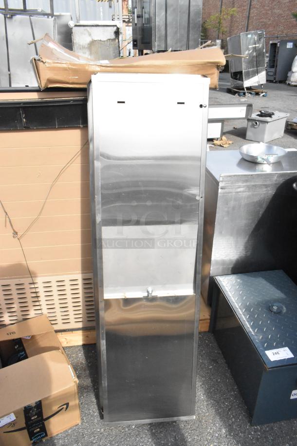 Brand new stainless steel wall mount trash and towel dispenser with visible light scratches.