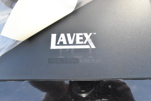 Brand new Lavex wall mount poly dispenser, black, with visible scratch and dent, part of lot of 2.