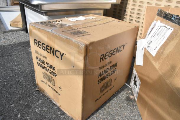 Boxed Regency 600HS12SP stainless steel single bay hand sink, scratch and dent condition, visible labels, made in Vietnam.