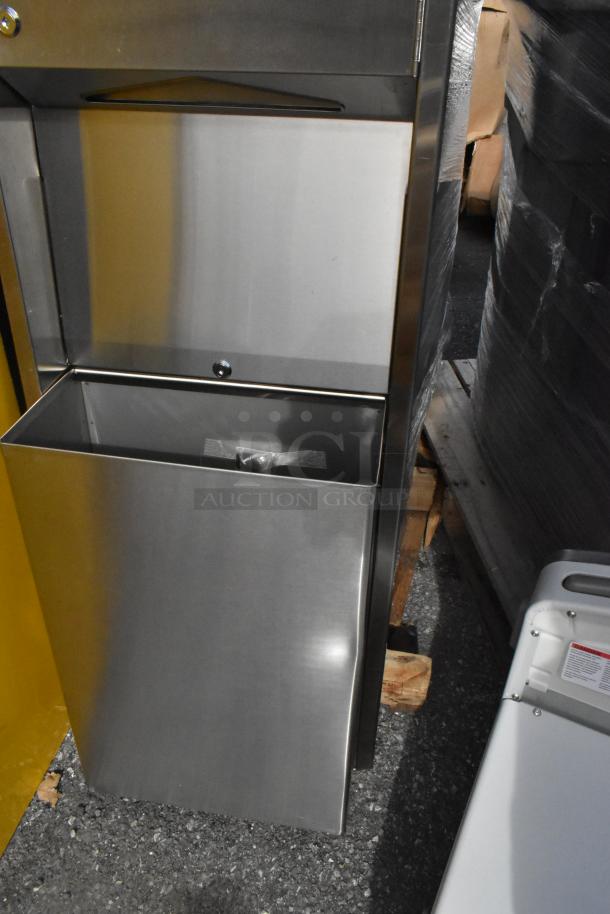 Stainless steel wall mount trash and towel dispenser, brand new with minor scratches, featuring a lockable compartment.