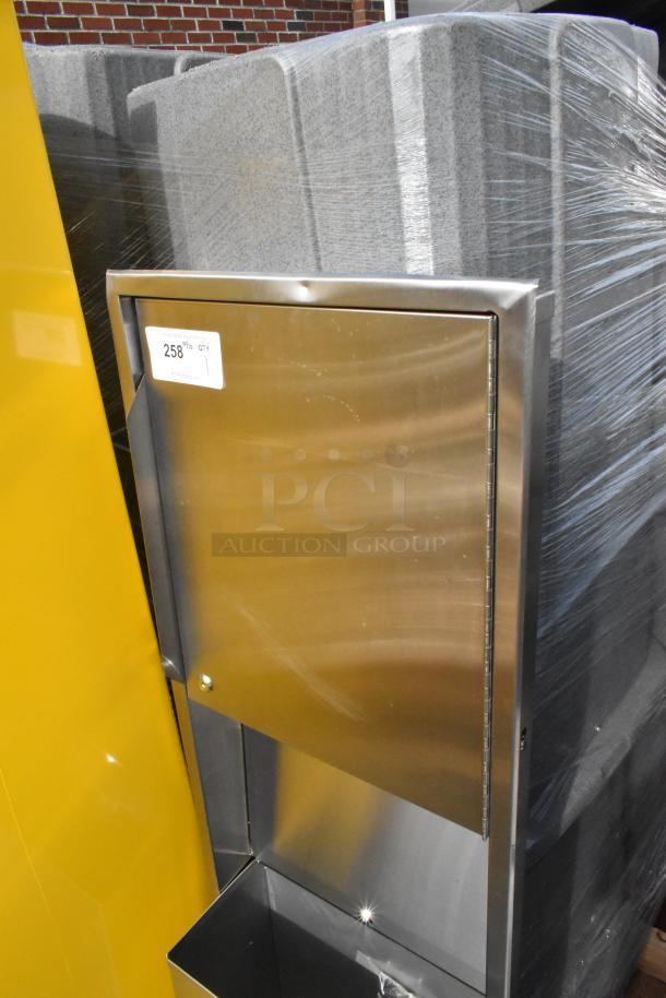 Stainless steel wall mount trash and towel dispenser, brand new with minor scratches and dents, Item #258 label visible.