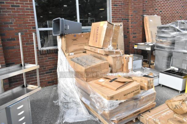 20 new scratch and dent items including sink, work table, and over shelf. Boxes stacked outdoors, some with visible damage.