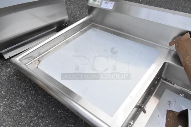 BRAND NEW Regency 50" 16-gauge stainless steel undercounter dishtable, sink on right. Minor scratches and dents visible.