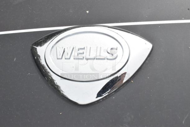 Wells logo on stainless steel surface of 5' self-contained grease hood.