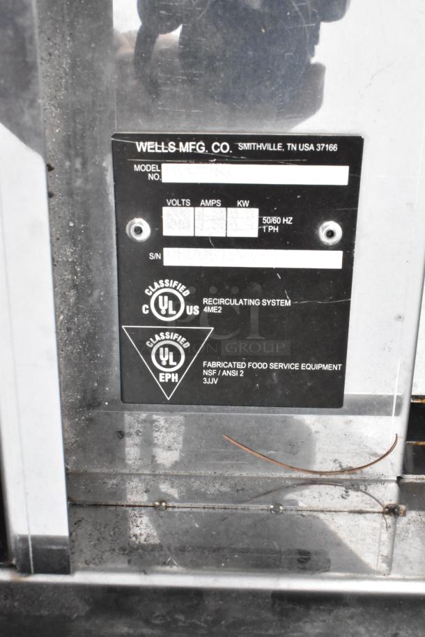 5' Wells stainless steel self-contained grease hood label showing model and serial number fields, UL and NSF classifications.