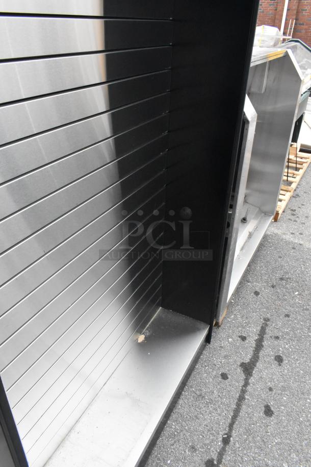 All State ASMMS491-DS Display Cabinet, stainless steel finish, slat wall design, minor wear, on pavement.