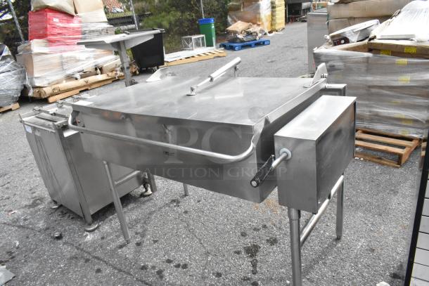 Stainless steel commercial floor-style braising pan with sturdy handles, in good condition, ideal for large-scale cooking.