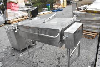 Stainless steel commercial floor-style braising pan with sturdy handles, in good condition, ideal for large-scale cooking.