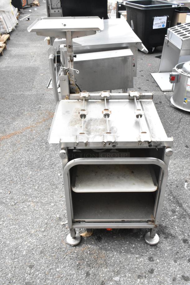 M&E Metal Equipment Stand with adjustable platform and two shelves; used condition with visible wear.