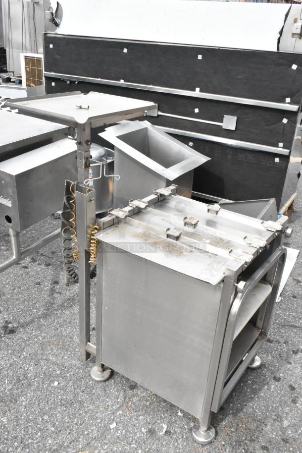 M&E Metal Equipment Stand, stainless steel, adjustable, with multiple compartments and locking mechanism. Used condition.