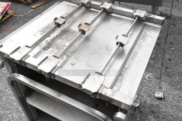 M&E Metal Equipment Stand, stainless steel, used condition with visible wear, sturdy frame, adjustable top rails.