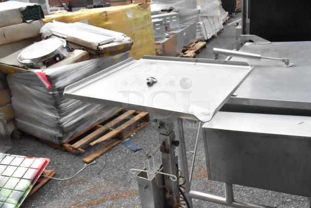 M&E metal equipment stand, sturdy design, adjustable height, minor surface wear, ideal for industrial use.