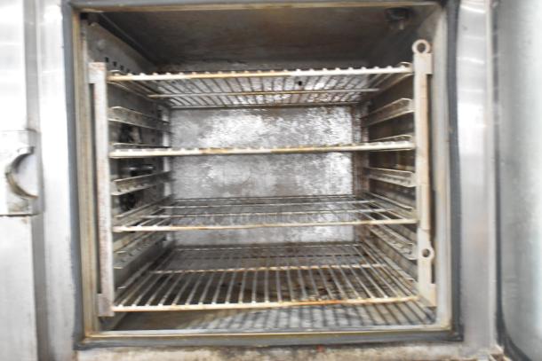 Alto Shaam CTP10-10E stainless steel combi convection oven interior, showcasing racks, signs of use, and slight wear.