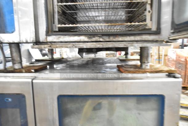 Stainless steel Alto Shaam commercial combi ovens, Model CTP10-10E, with equipment stand. Note: broken glass visible.