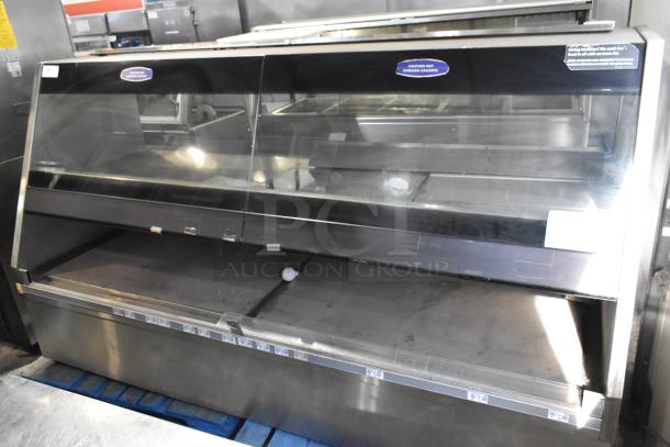 Metal Commercial Floor Style Merchandiser, large display case with glass front, stainless steel body, visible caution labels, used condition.