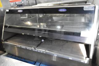 Metal Commercial Floor Style Merchandiser, large display case with glass front, stainless steel body, visible caution labels, used condition.