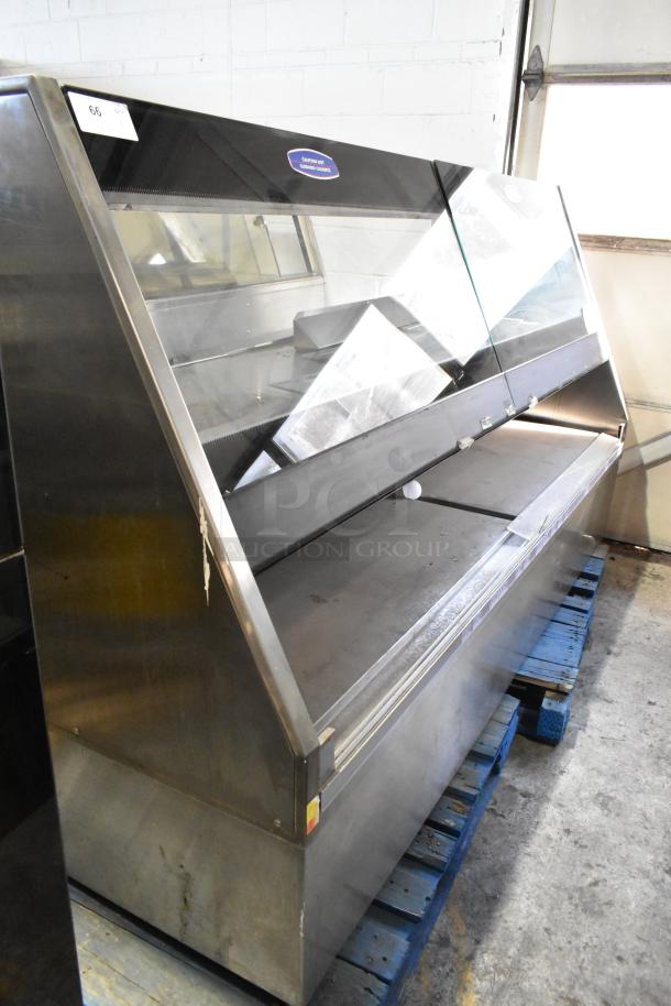 Metal commercial floor style merchandiser, stainless steel, glass front, minor wear, interior shelving, sell tag on top.