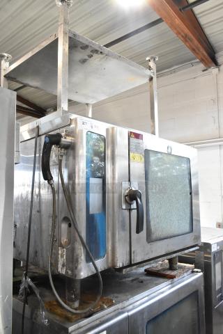 Alto Shaam 7.14 ESI Stainless Steel Commercial Electric Powered Combi Convection Oven w/ Equipment Stand. See Pictures for Broken Glass. Includes Model 7.14 ESI. 208/240 Volts, 3 Phase. - Item #1212404