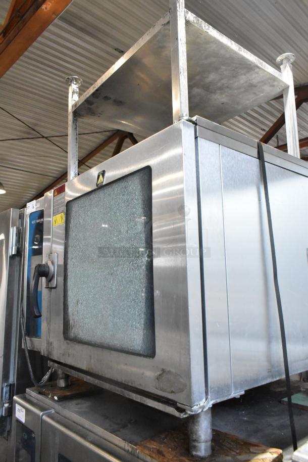 Alto Shaam 7.14 ESI stainless steel combi oven with stand, showing broken glass door. Model 7.14 ESI, 208/240V, 3 phase.