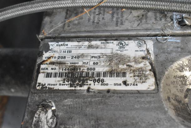 Alto Shaam 7.14 ESI label indicating model, voltage (208-240V), and serial number. Tags show signs of wear.