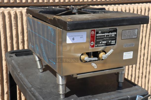 Town SR-24-G-SS Natural Gas Grate Top Stock Pot Range with bent legs. Stainless steel, dual control panel. Visible labels.