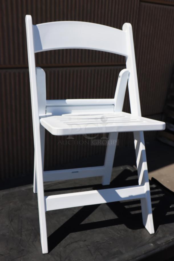 White resin folding chair with slatted seat by Lancaster Table & Seating, model 427FCRSLTWHT. Packaging damaged, new condition.