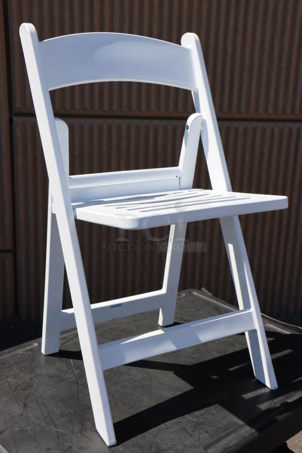 Lancaster Table & Seating white resin folding chair, Model 427FCRSLTWHT, slatted seat, new but packaging damaged, minor scratches possible.