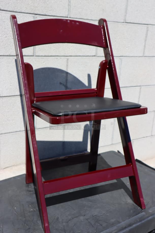 BRAND NEW Lancaster Table & Seating 427FCRVINMAH mahogany resin folding chair with black vinyl seat; light scratching visible.