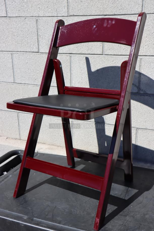 BRAND NEW Lancaster Table & Seating 427FCRVINMAH mahogany resin folding chair with vinyl seat, light scratching visible.